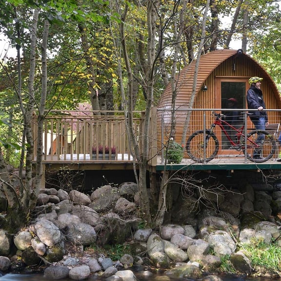 Glamping pod with man on bike outside
