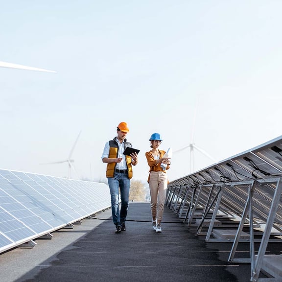 Man and woman in hard hats walking