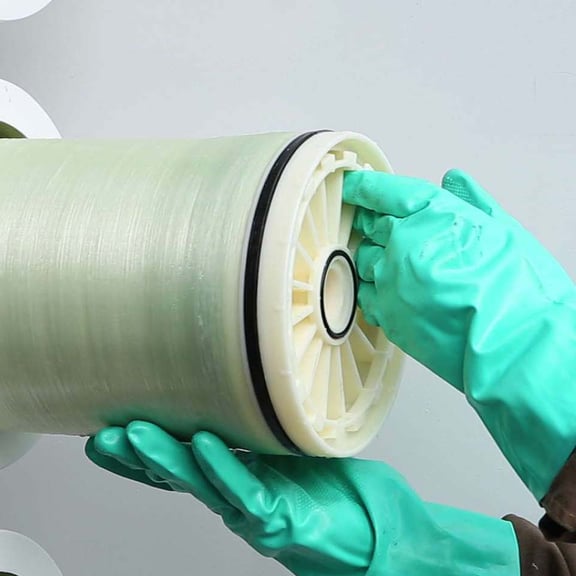 Leachate treatment with person wearing rubber gloves