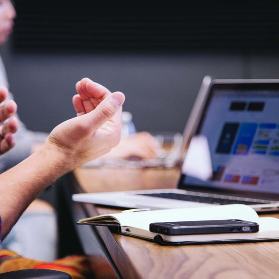 Laptop on desk with mobile phone