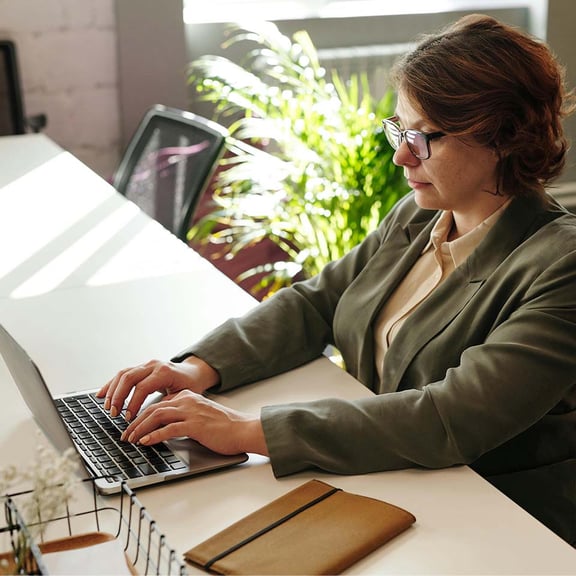 Woman sitting at desk on laptop