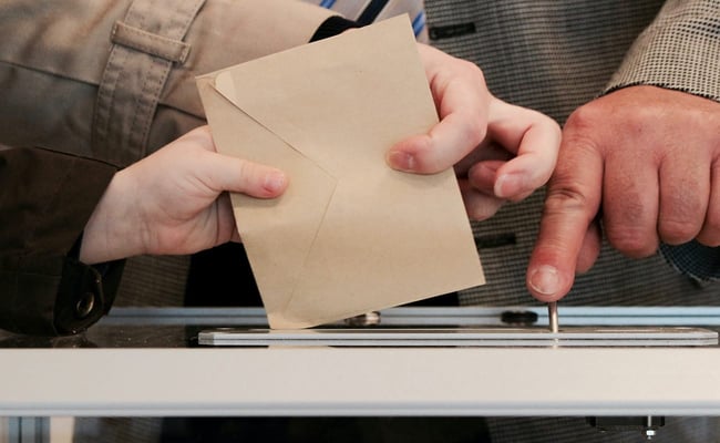 putting envelope in voting box