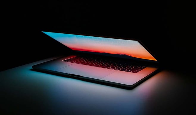 Half open laptop on dark background