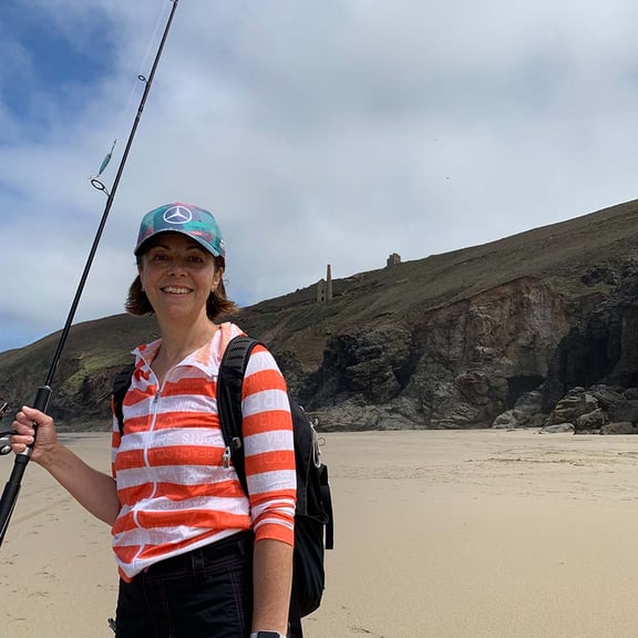 Caron on the beach with fishing rod