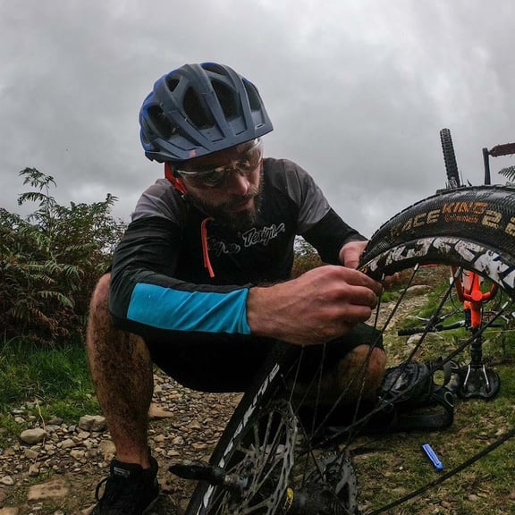 Rob fixing his bike wheel