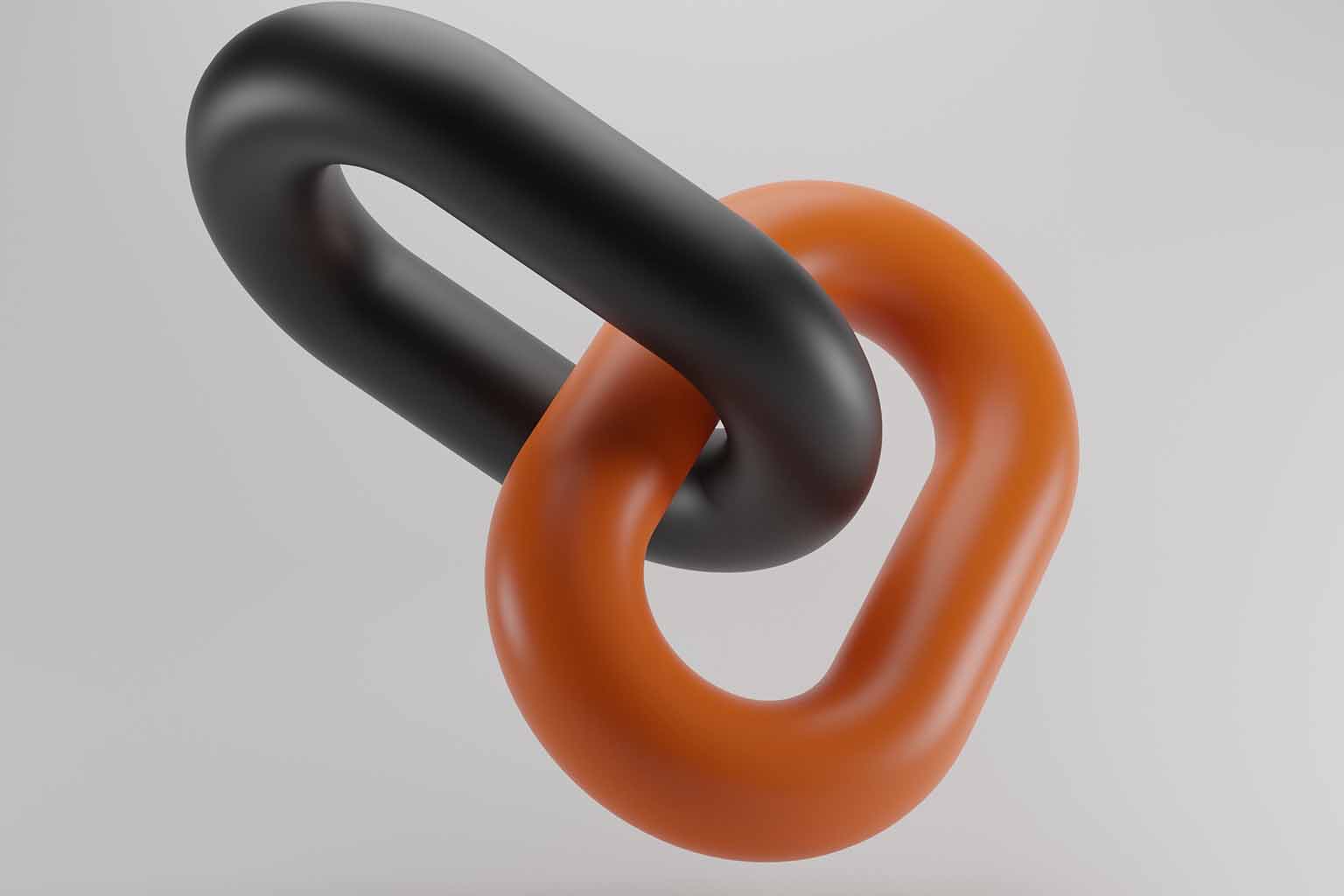 A close-up image of a black link and an orange link linked together