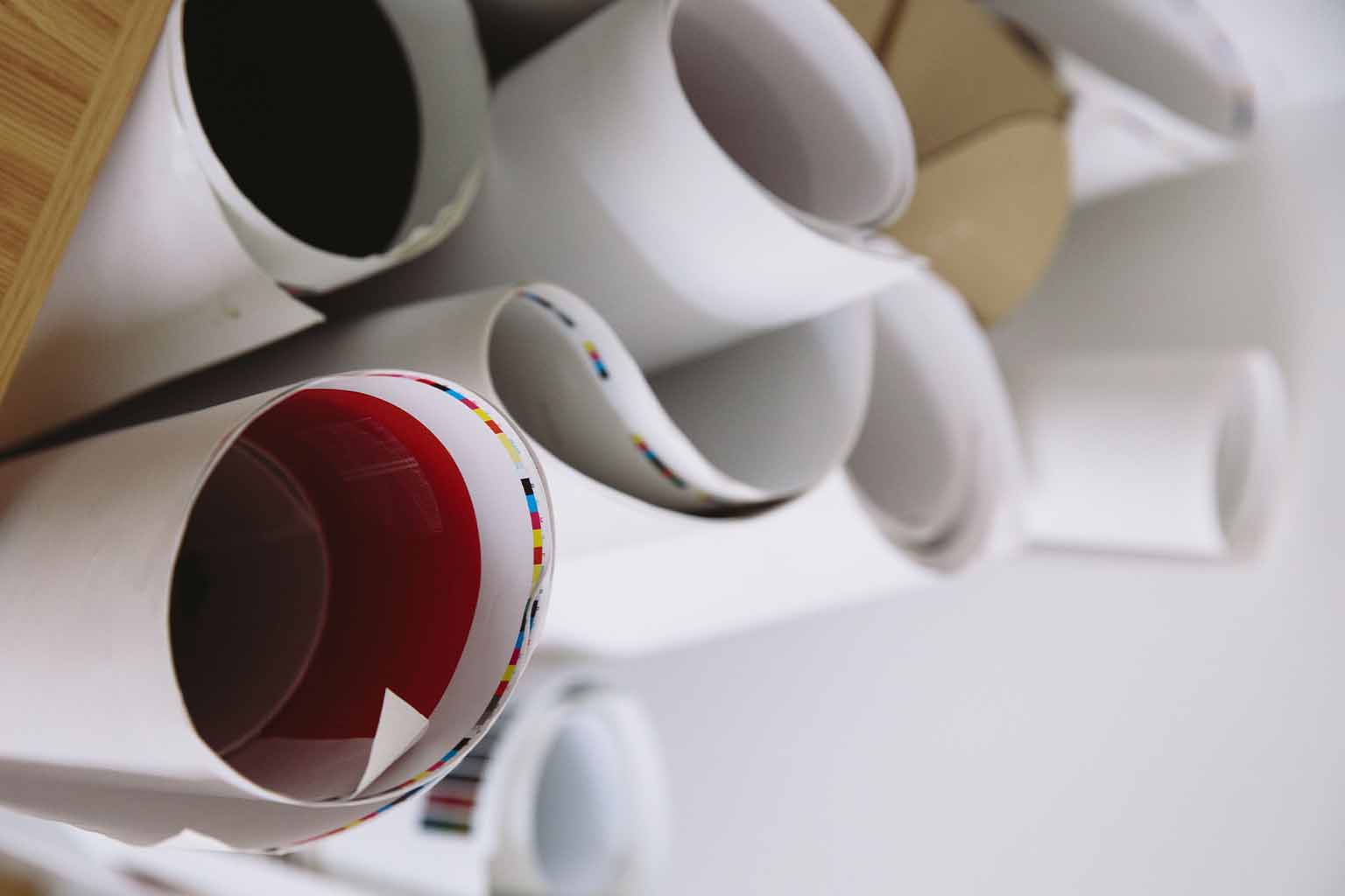 Rolled-up CMYK poster prints