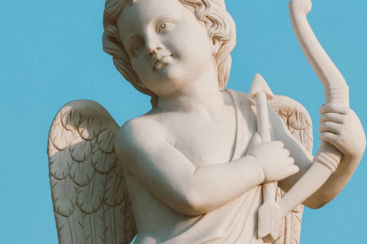 A statue of Cupid with arrow and bow at rest against their chest