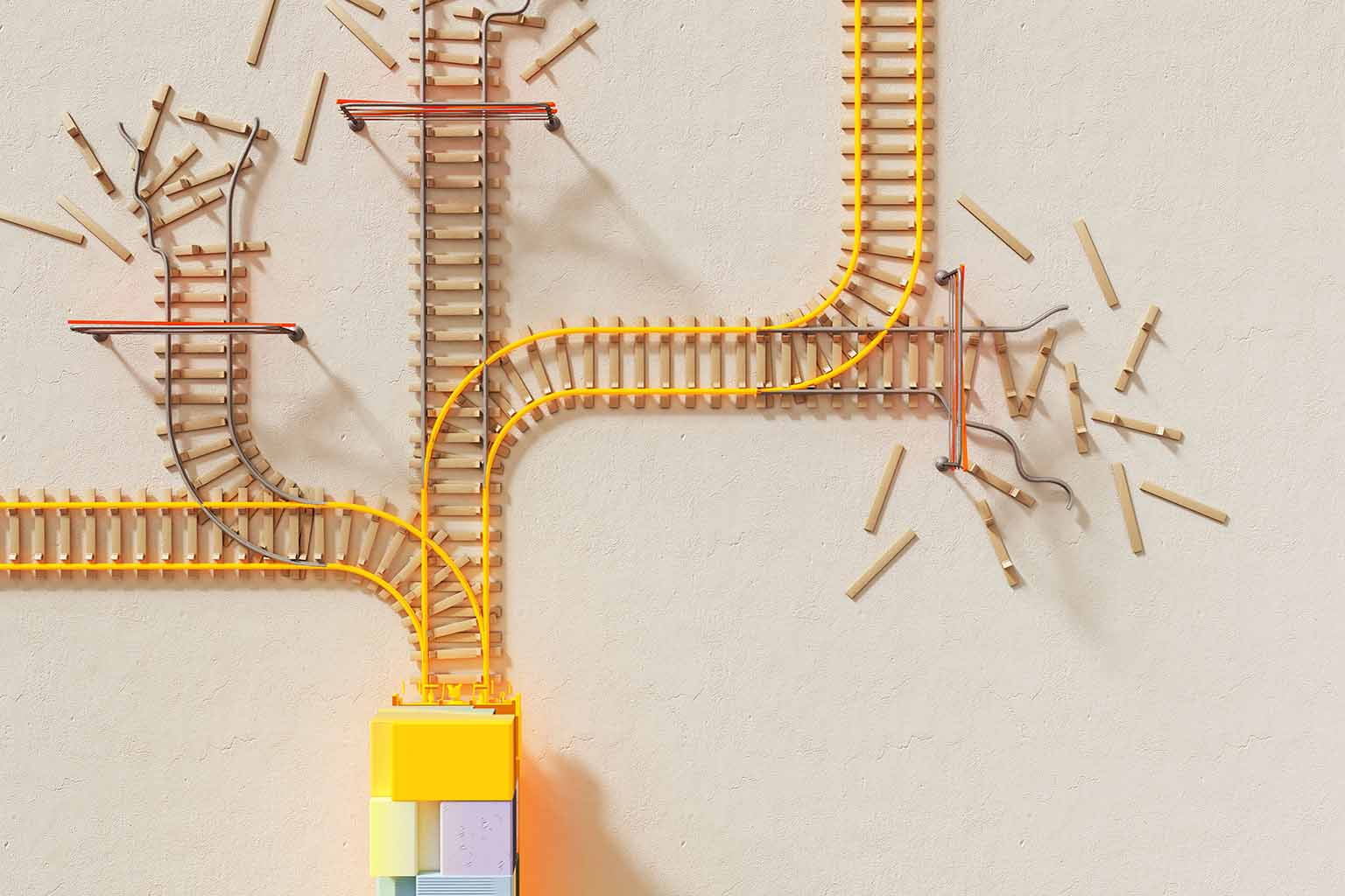 A bird's-eye view of a model train track splitting into five distinct tracks as it exits a vibrant coloured tunnel. Three of the five tracks are condemned.