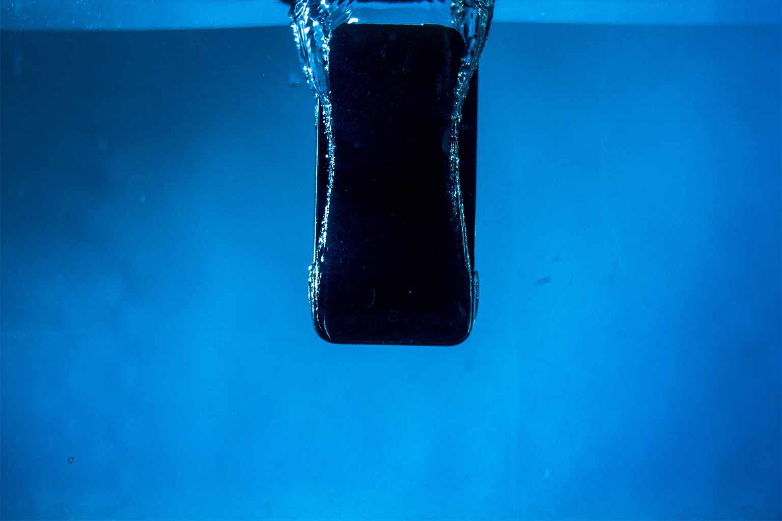 A smartphone sinking underwater