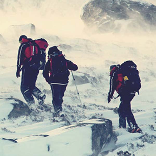 People climbing up a snowy mountain