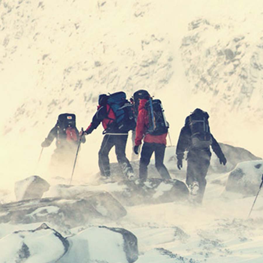 People climbing up a snowy mountain