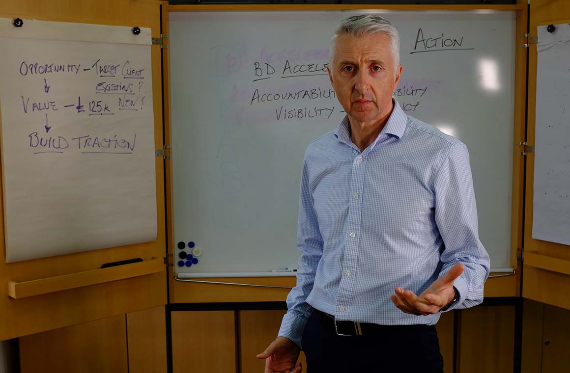 Cameron Carnegie in front of white board