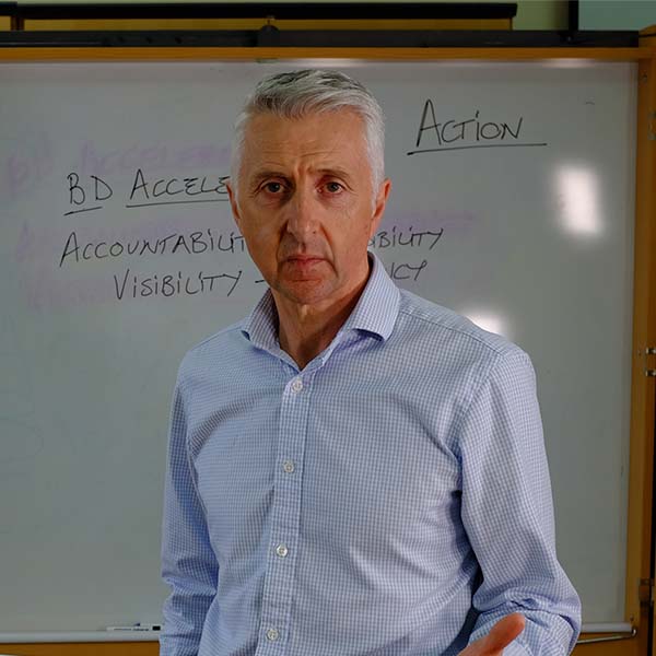 Cameron Carnegie in front of white board