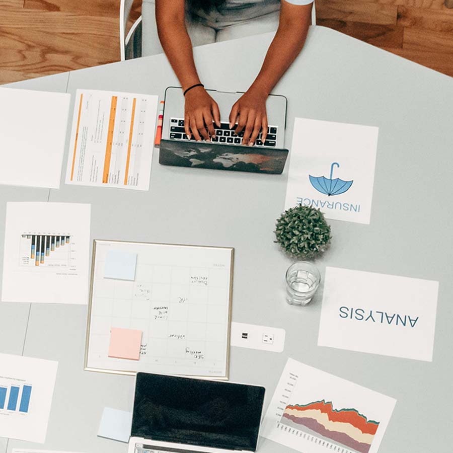 Various people round a desk working 